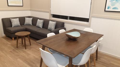 a living room with a table and a couch at NRMA Victor Harbor Beachfront Holiday Park in Victor Harbor
