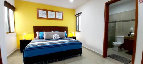 a bedroom with a bed and a bathroom with a shower at Suite Isla Mujeres in Isla Mujeres
