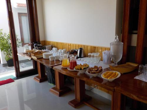 a table with breakfast foods and drinks on it at Villa Loan A HOI AN in Hoi An