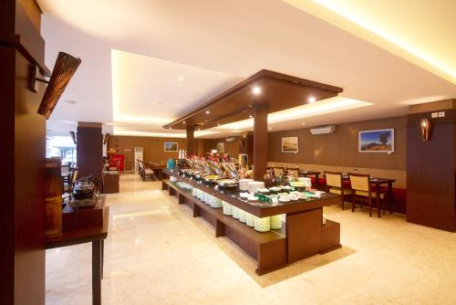 a lobby with a long buffet in the middle of a room at LYNN Hotel by Horison in Yogyakarta