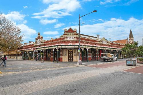 a large building on a street in a city at Fremantle Port Mill Bed & Breakfast - Unique Accommodation in Fremantle