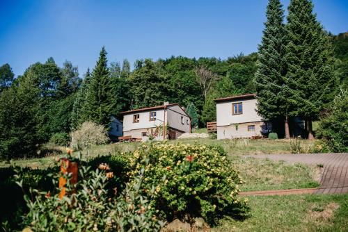 a couple of houses in a field with trees at U Haliny - Tyra Natura in Třinec