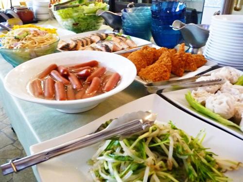 a table topped with plates of food and bowls of food at Hotel New White House in Rumoi