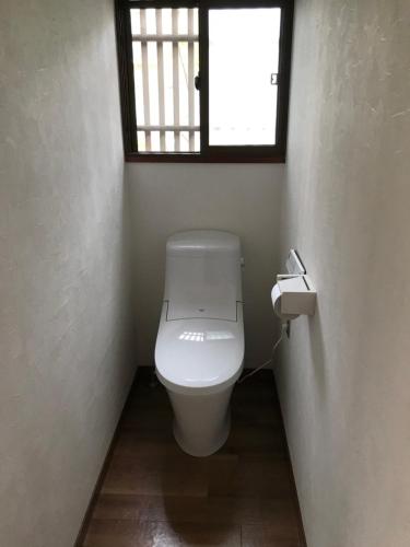 a bathroom with a toilet and a window at Children's cafe B&B Kimie in Kamakura