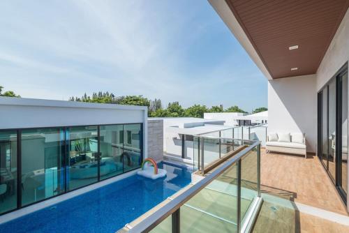 an image of a swimming pool on the balcony of a house at Movenpick Residences 3-Bedroom Pool Villa Beach Access, Na Jomtien Pattaya in Na Jomtien