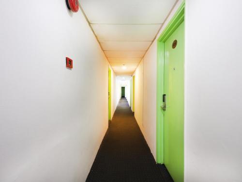a corridor in an office building with green and white walls at Seremban Inn in Seremban