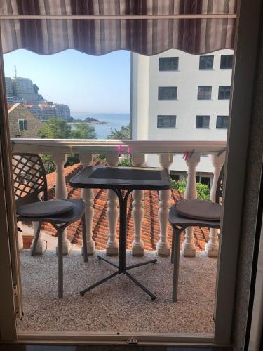 a view of a balcony with two chairs and a table at Apartments Djuro Rafailovic in Budva