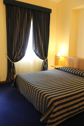 a hotel room with two beds and a window at La Fonte dell'Astore in Castelpetroso
