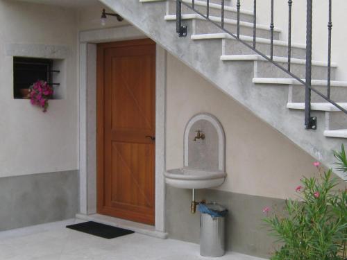 a bathroom with a sink next to a stairs at Guesthouse Muha in Lipica