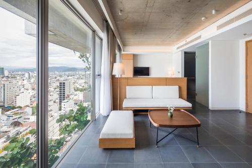 a bedroom with a bed and a table at Chicland Boutique Danang Beach Hotel in Da Nang