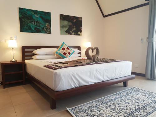 a bedroom with a bed with a swan on it at Cote d'Or Footprints in Baie Sainte Anne