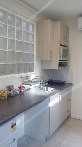 a kitchen with a sink and a counter top at Randwick City Lodge 2 in Sydney