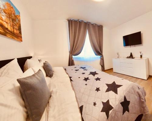 Un dormitorio con una cama con estrellas negras. en Apartament Comfort Primaverii en Rîşnov