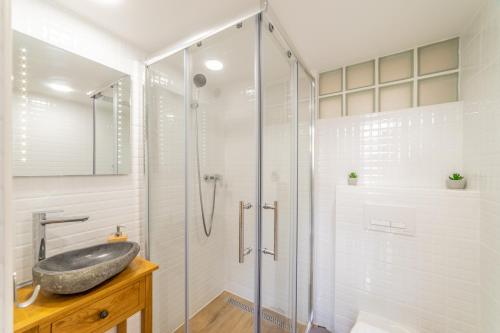 a bathroom with a sink and a shower at Paulay Boutique Residences Downtown in Budapest
