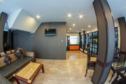 a living room with a couch and a table at The Train Hotel Hatyai in Hat Yai