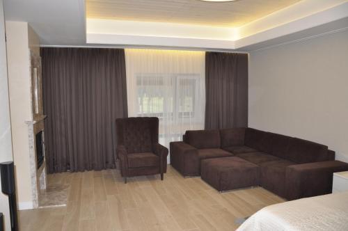 a living room with a couch and a chair at Park-Hotel Tihiy Les in Prokhorovka