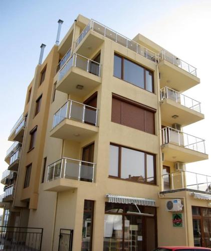 a building with balconies on the side of it at Apartment Turquoise Sozopol in Sozopol