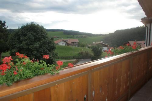a balcony with flowers on a wooden fence at Residence Viktoria in Castelrotto