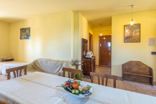 a room with a table with a bowl of fruit on it at Fattoria Capobianco in Montefiascone