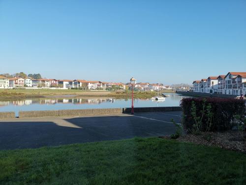 a view of a river with boats in the water at Socoa, Ciboure, Saint Jean de Luz, grand studio proche plage in Ciboure