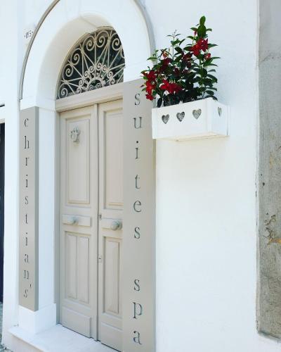 a door with a planter on the side of a building at Christian's Suites & Spa in Fasano