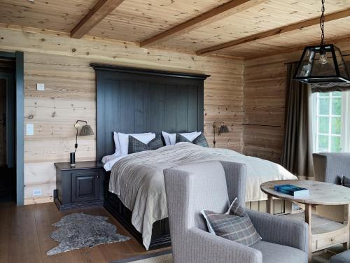 a bedroom with a bed and a wooden wall at Storfjord Hotel in Skodje