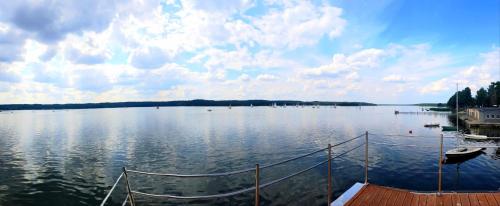 a large body of water with a boat in it at Domy na wodzie Charzykowy in Charzykowy