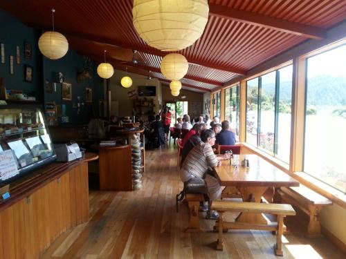 a group of people sitting at a table in a restaurant at Berlins cafe, bar and backpackers in Newton Flat