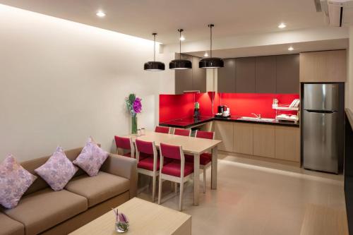 a kitchen and living room with a couch and a table at Mercure Hai Phong in Hai Phong
