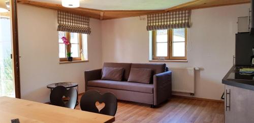 a living room with a couch and a table at Ferienwohnung Bader in Bolsterlang