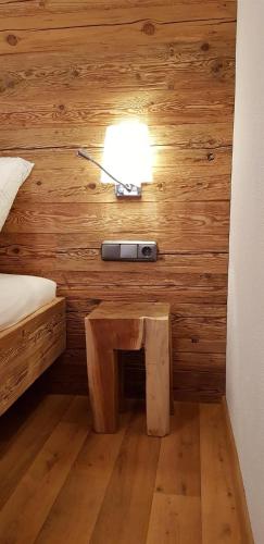 a bedroom with a bed and a lamp on a wall at Ferienwohnung Bader in Bolsterlang