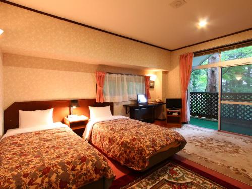 Postel nebo postele na pokoji v ubytování Hotel Mumon