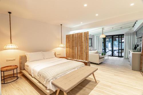 a bedroom with a bed and a living room at F & S LOUNGE SUITES in Parga