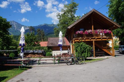 a bike parked in front of a building with umbrellas at Luise Wehrenfennig & Haus EvA in Bad Goisern