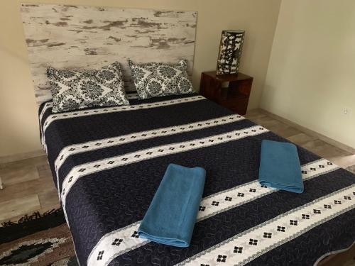 a bedroom with a large bed with blue pillows at Villa Füred in Balatonalmádi