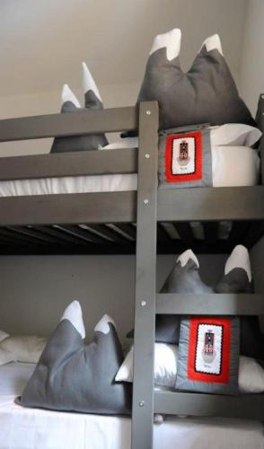 a bunk bed with pillows on the bottom bunk at Luxury Grimentz Apartment in Grimentz