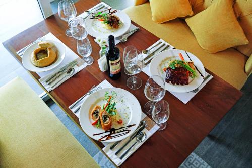 a table topped with plates of food and wine glasses at Hotel Carlito Tagaytay in Tagaytay