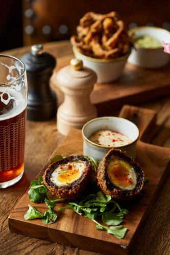 a plate of food with eggs on a table with a drink at Crown and Anchor in Marlborough