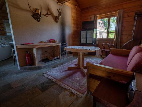 a living room with a table and a fireplace at Villa Lohusalo I with Sauna in Lohusalu