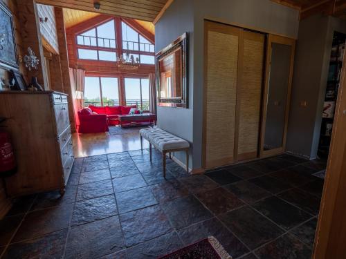 a living room with a bench in the middle of a room at Villa Lohusalo I with Sauna in Lohusalu