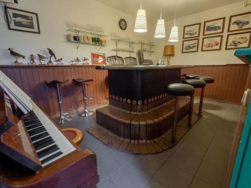 a bar with a piano and a bar counter at Villa Lohusalo I with Sauna in Lohusalu