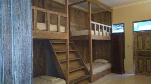 a couple of bunk beds in a room at Sama Sama Bungalows in Gili Trawangan