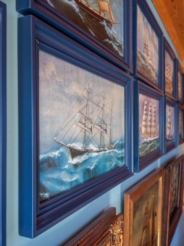 a painting of a ship in the ocean on a wall at Villa Lohusalo I with Sauna in Lohusalu