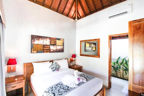 a bedroom with two beds and a window at Villa Casablanca Surf Keramas in Keramas