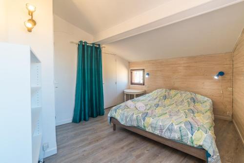 a bedroom with a bed and a green curtain at Apt terrasse centre historique in Grasse