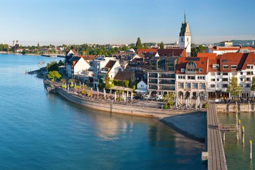 a group of buildings next to a body of water at Ringhotel Krone in Friedrichshafen
