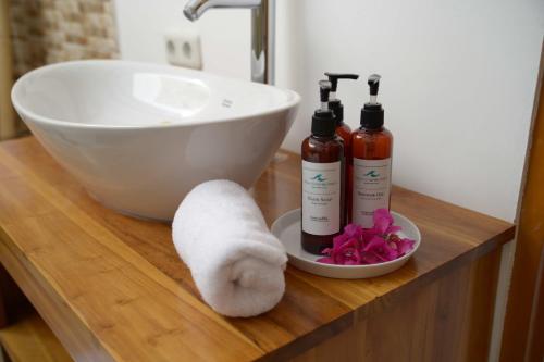 a bathroom counter with a sink and a towel at Villa Casablanca Surf Keramas in Keramas