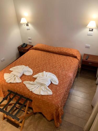 a hotel room with a bed with towels on it at Hotel Select in Mar del Plata