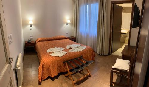 a hotel room with a bed with towels on it at Hotel Select in Mar del Plata