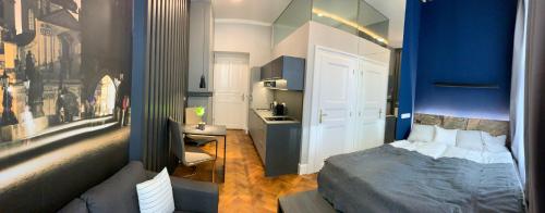 a bedroom with a bed and a blue wall at Holec Apartments in Prague
